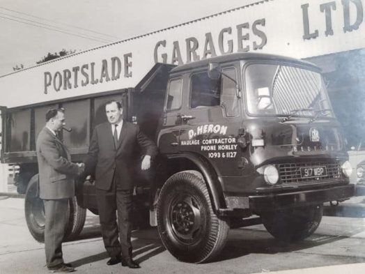 David Heron's father leaning toward his truck while giving a handshake